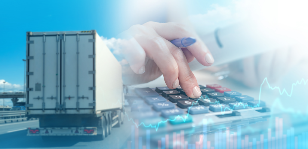 Hand using calculator overlaid with semi-truck and freight data graphics representing transportation cost calculations